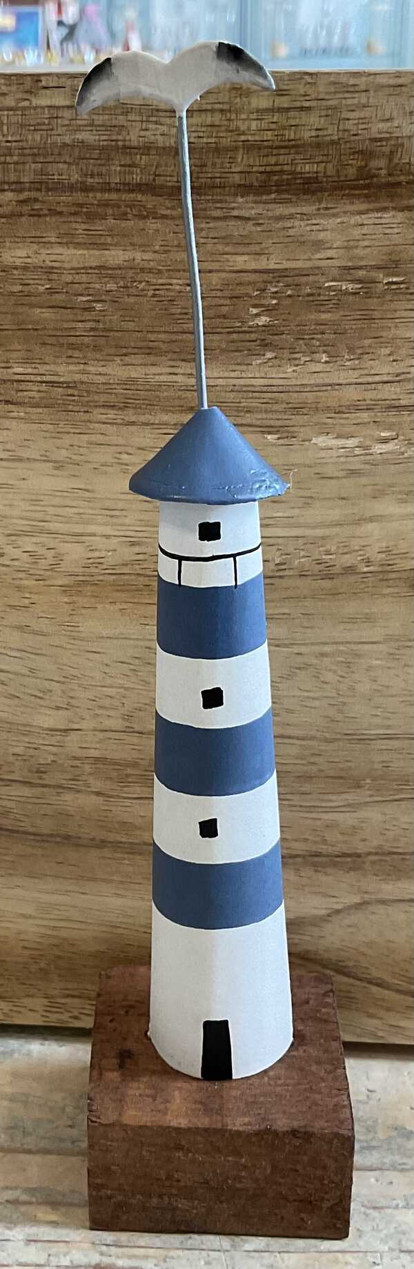 Decorative wooden lighthouse with seagull in blue